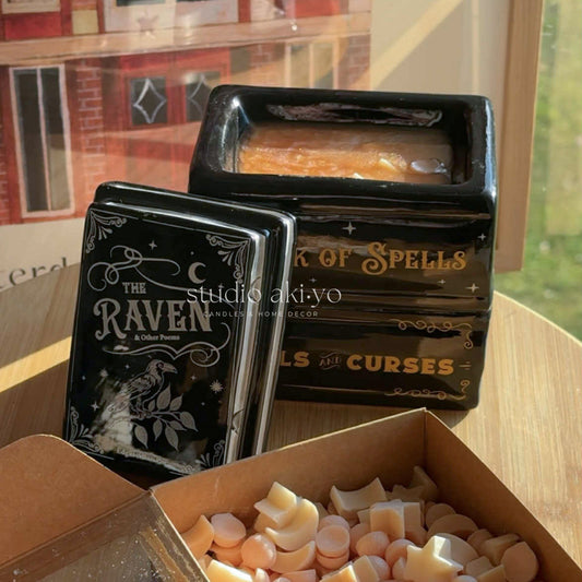 Hocus Pocus stack of books wax melt burner with decorative titles on a wooden surface, with a neutral background.