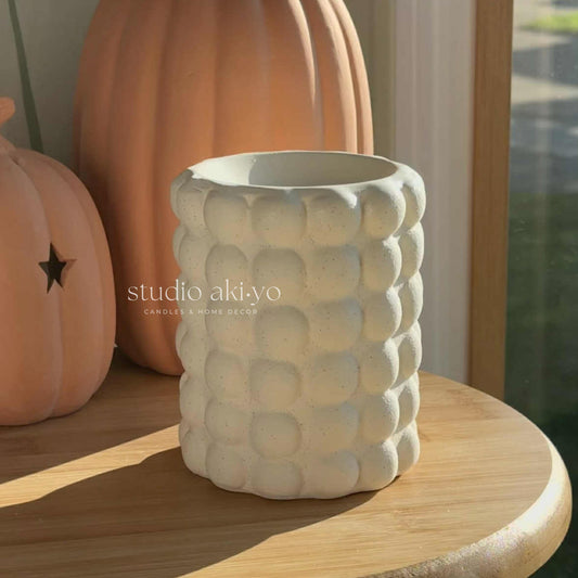 Bubble cream speckle wax burner styled in a pumpkin, seasonal decor.