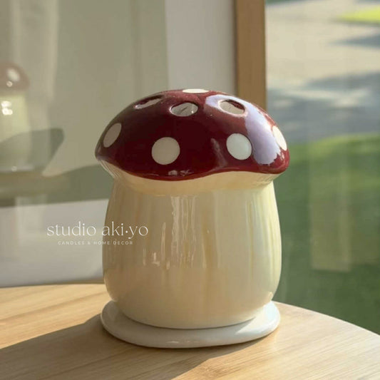 Ceramic mushroom incense cone holder shaped like toadstool with top hole