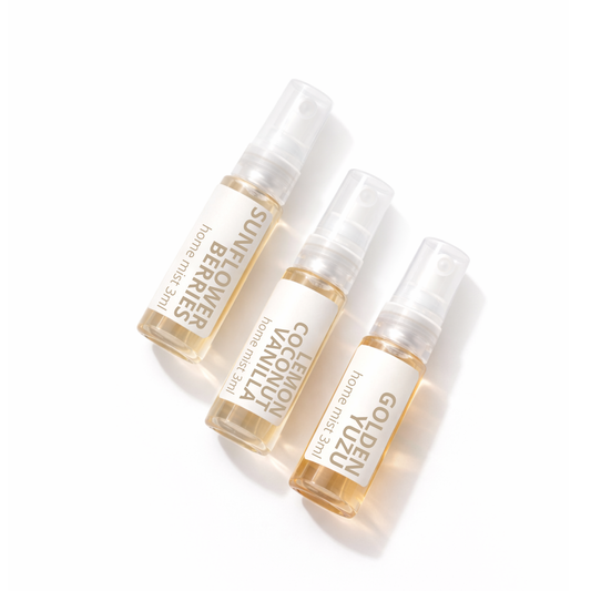 Three small Studio Akiyo home mist bottles with visible brand names on a white background. Featuring Scents Sunflower Berries, Lemon Coconut Vanilla and Golden Yuzu.