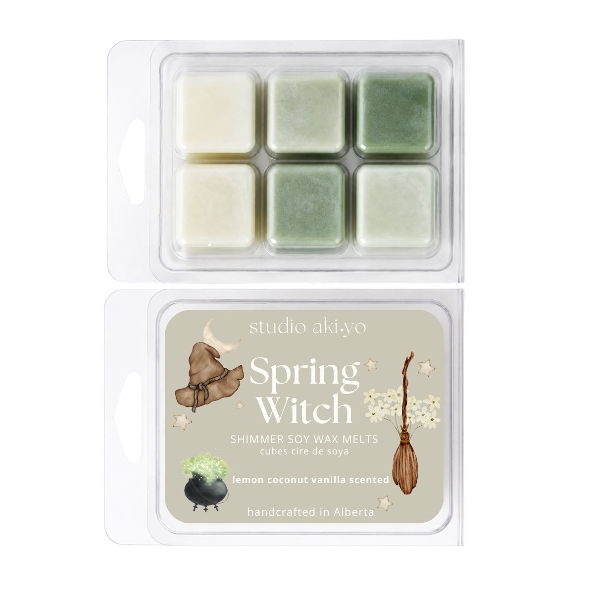 Two clear plastic clamshell packages of Studio Akiyo Spring Witch shimmer soy wax melts. The top package contains six wax cubes in pale cream and light green shades.
