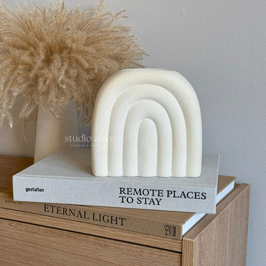 Arch cream-speckle ceramic wax melt burner styled in neutral home décor setting