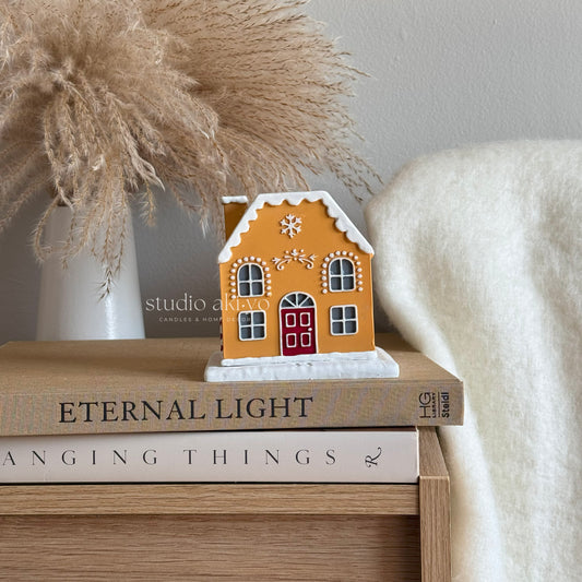 Candy Cane Gingerbread Incense Cone Holder on a shelf with books and a vase in the background