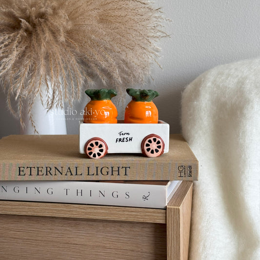 Carrot salt and pepper shakers in a lovely ceramic cart