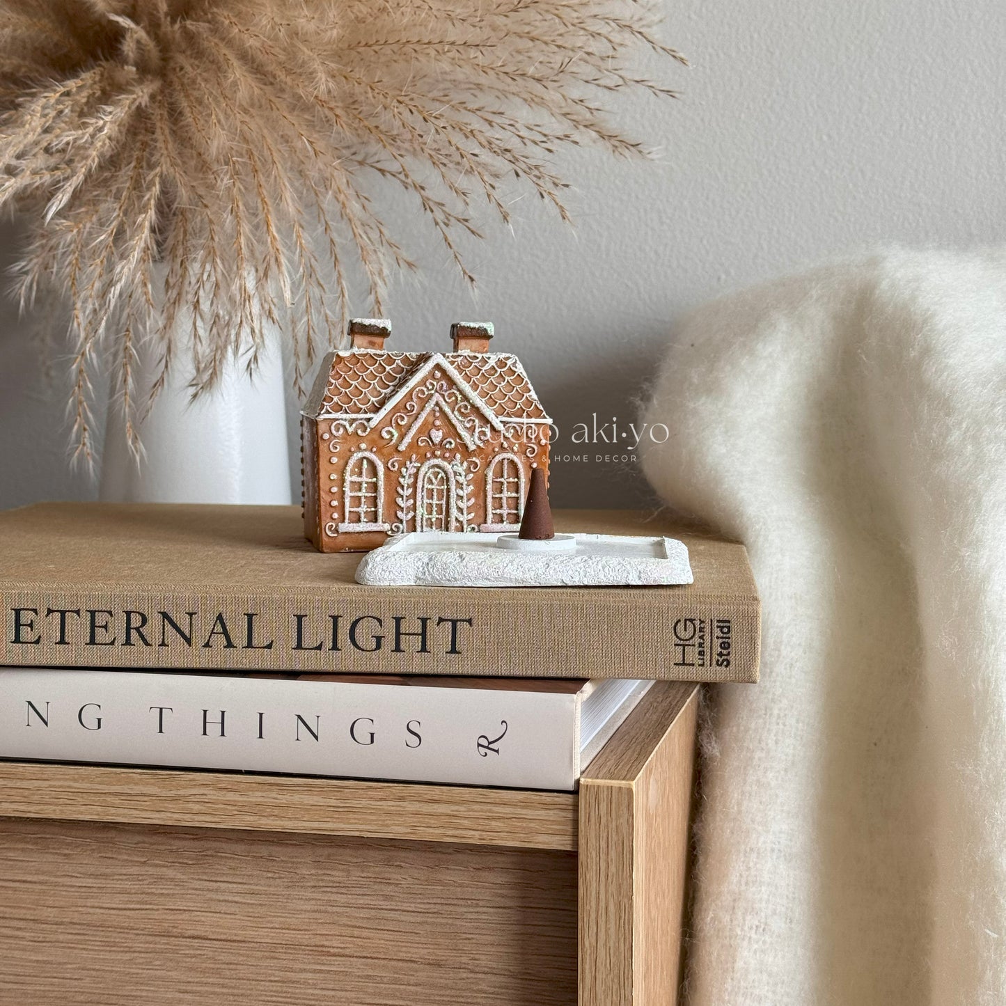 Decorative gingerbread house on books with a soft background