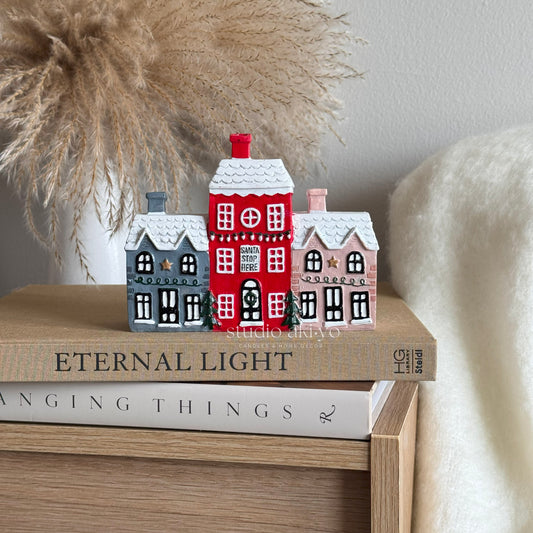 Holiday Village Incense Cone Holder on books with a neutral background