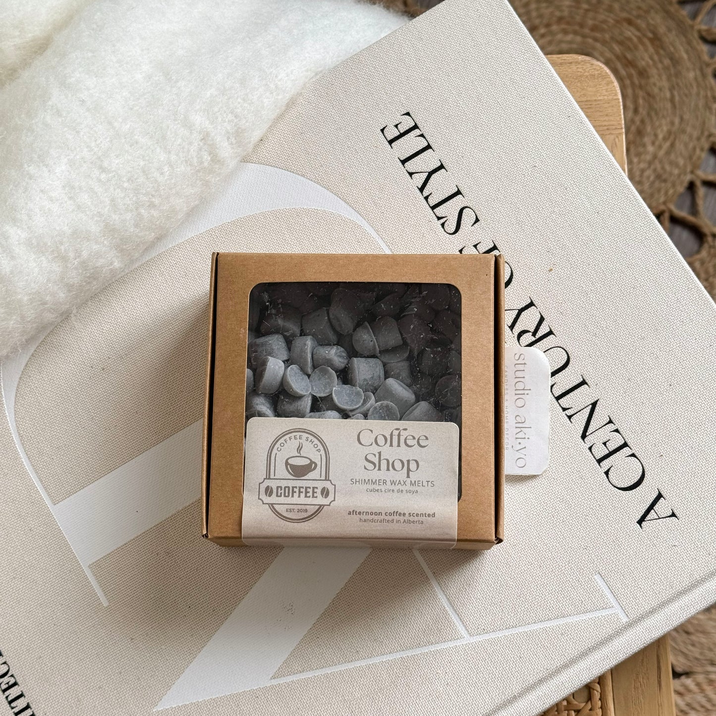 Box of coffee shop-themed wax melts on a book