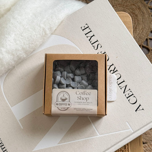 Box of coffee shop-themed wax melts on a book