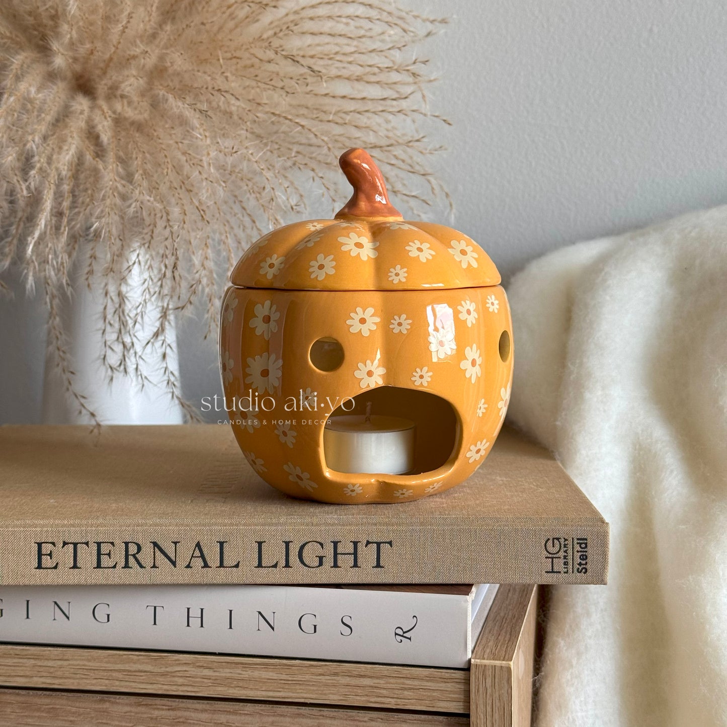 Groovy 60s-style ceramic floral pumpkin wax melt burner using tealight candles