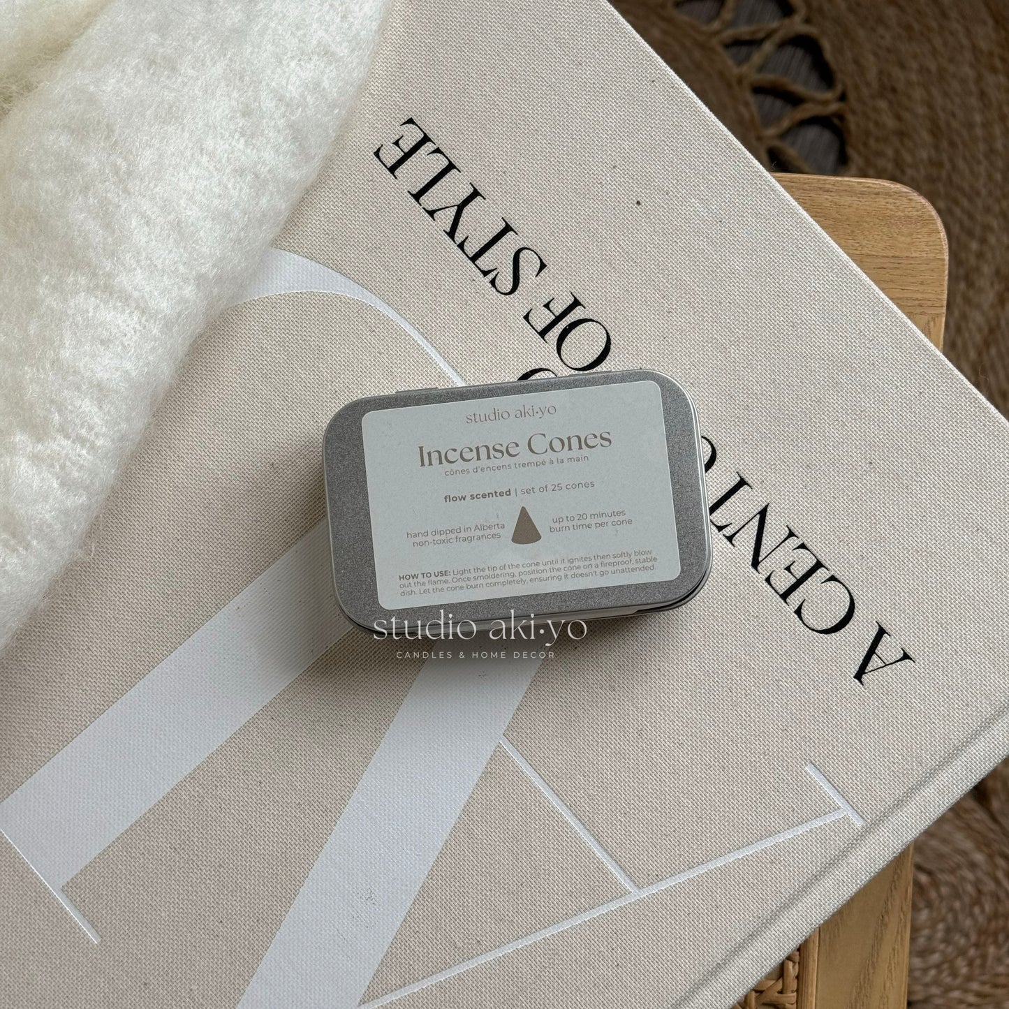 Metal tins with hand dipped incense cones called Flow