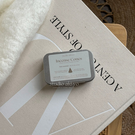 Metal tins with hand dipped incense cones called Flow