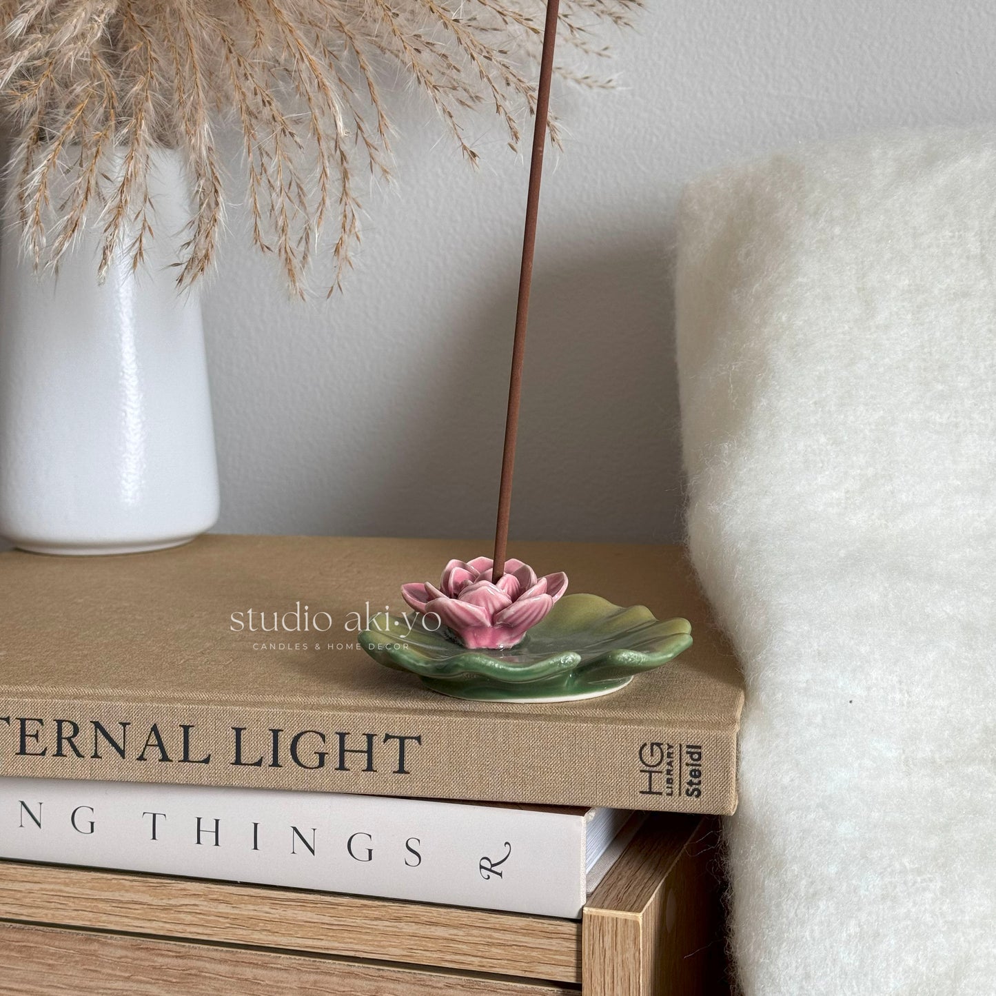 Lily pad incense holder holding incense stick and collecting ash