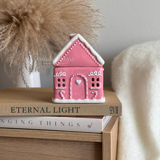 Pink ceramic gingerbread house wax melt burner, perfect for the holiday season.