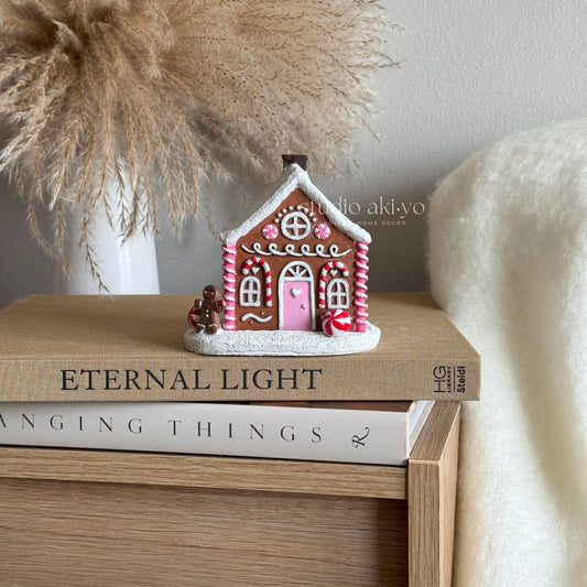 Pink Gingerbread Incense Cone Holder on books with a neutral background