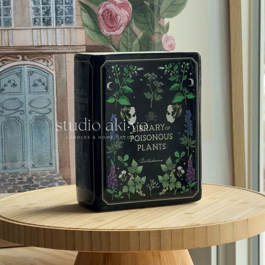 Decorative box with botanical design on a wooden table, featuring the brand 'studio akiyo'.