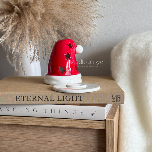 Red and white decorative item on a stack of books with 'studio akiyo' branding.