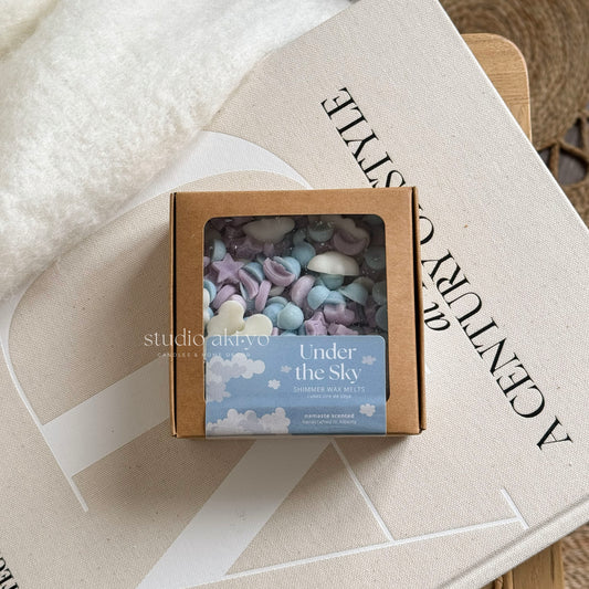 Under the sky wax melt scoopies shaped like a starry skies filled with clouds and stars