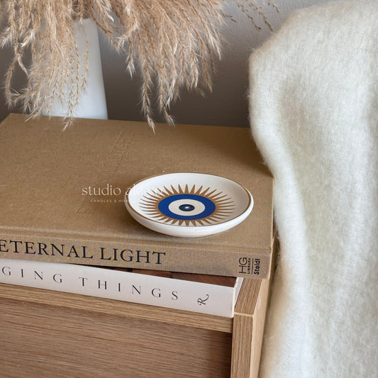 Decorative plate on top of books with a neutral background