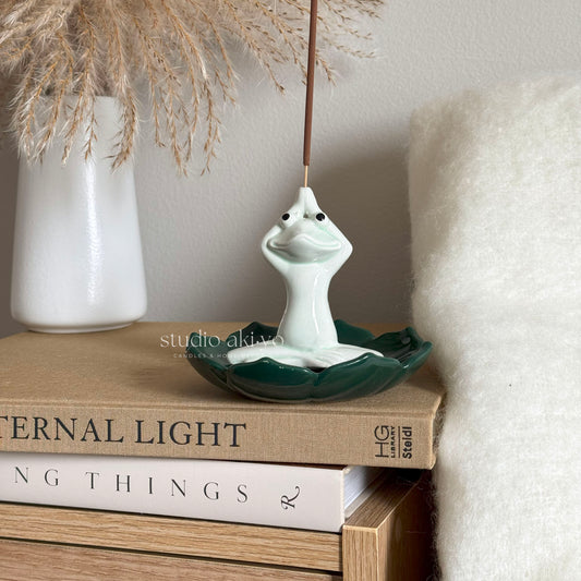 Yoga frog incense burner with stick upright and ash collecting below