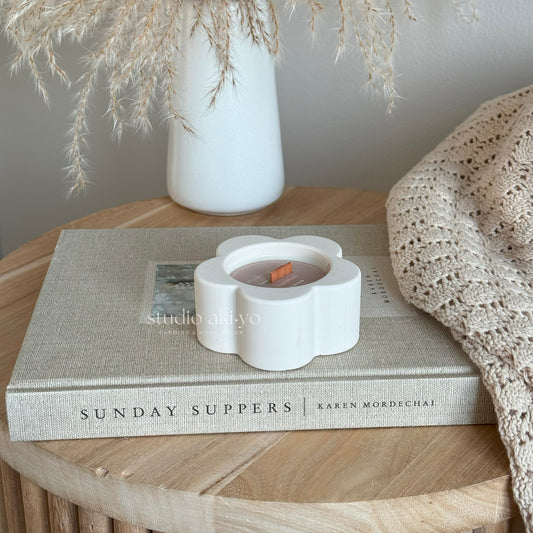 Hand-poured yuzu candle in artisan neutral flower shaped vessel