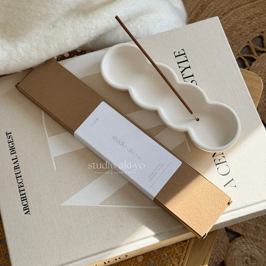 Incense stick holder with incense sticks Flow from Studio Akiyo.