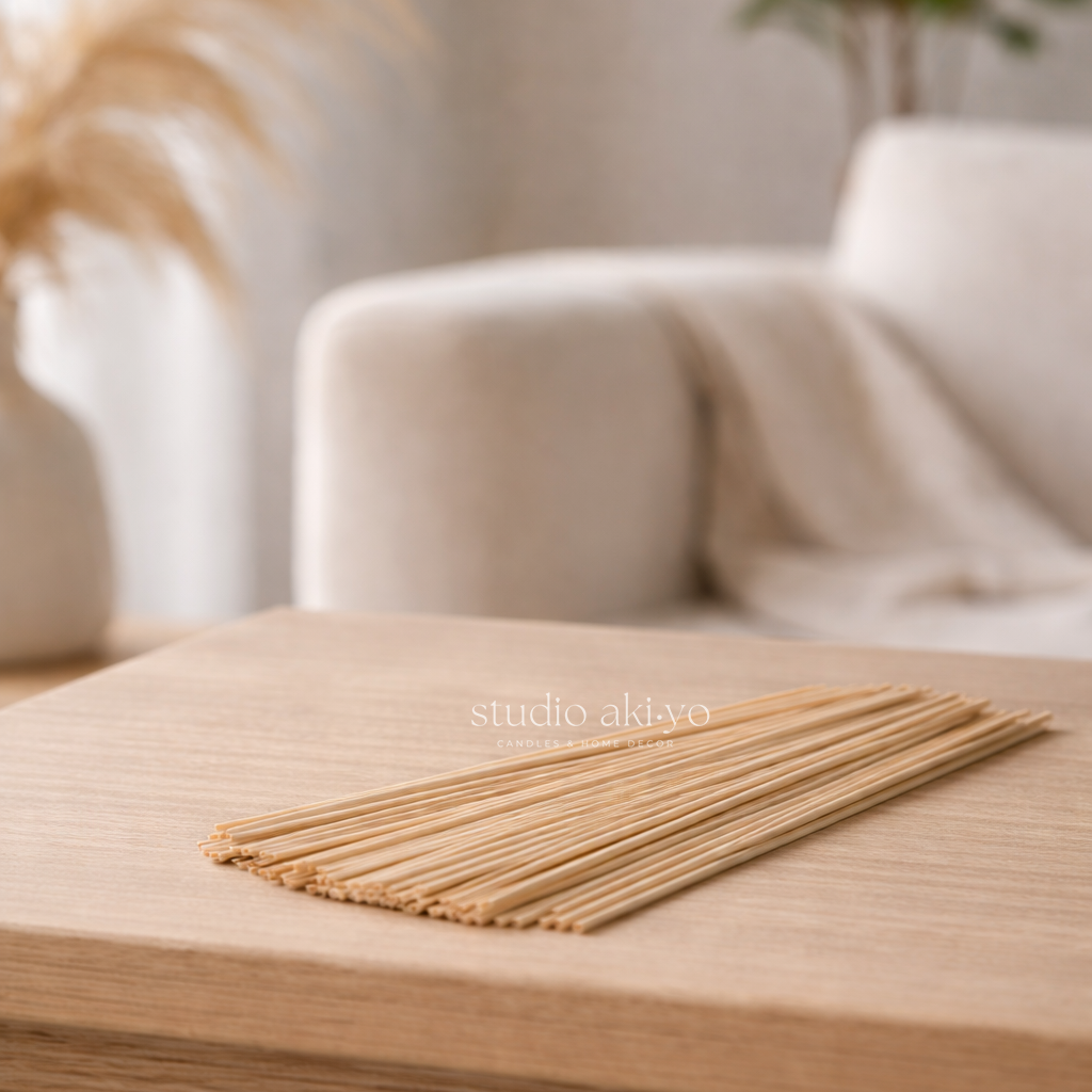 Natural reed sticks for reed diffusers on a wooden surface with a blurred background