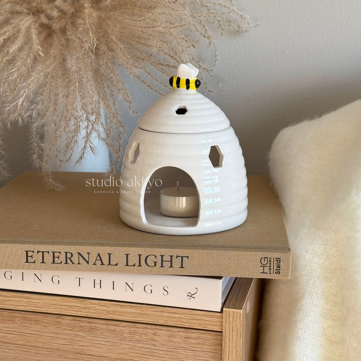 Beehive wax melt burner styled in cottagecore décor with pampass plant
