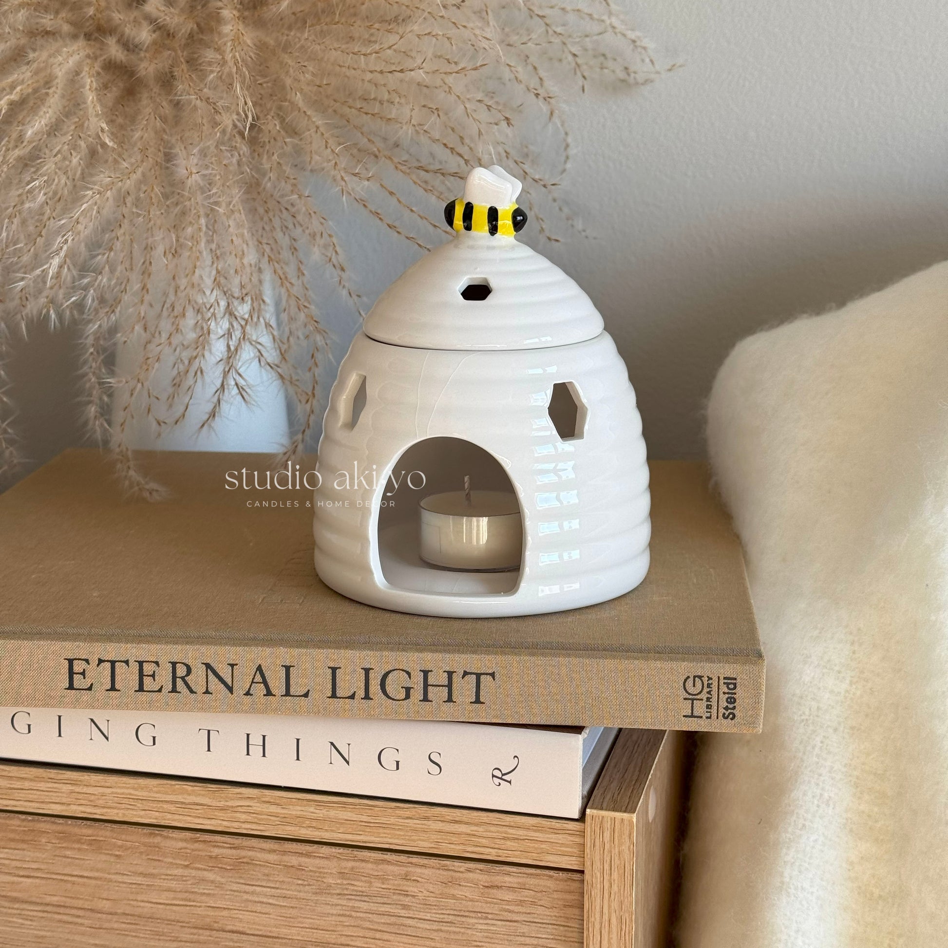 Beehive wax melt burner styled in cottagecore décor with pampass plant