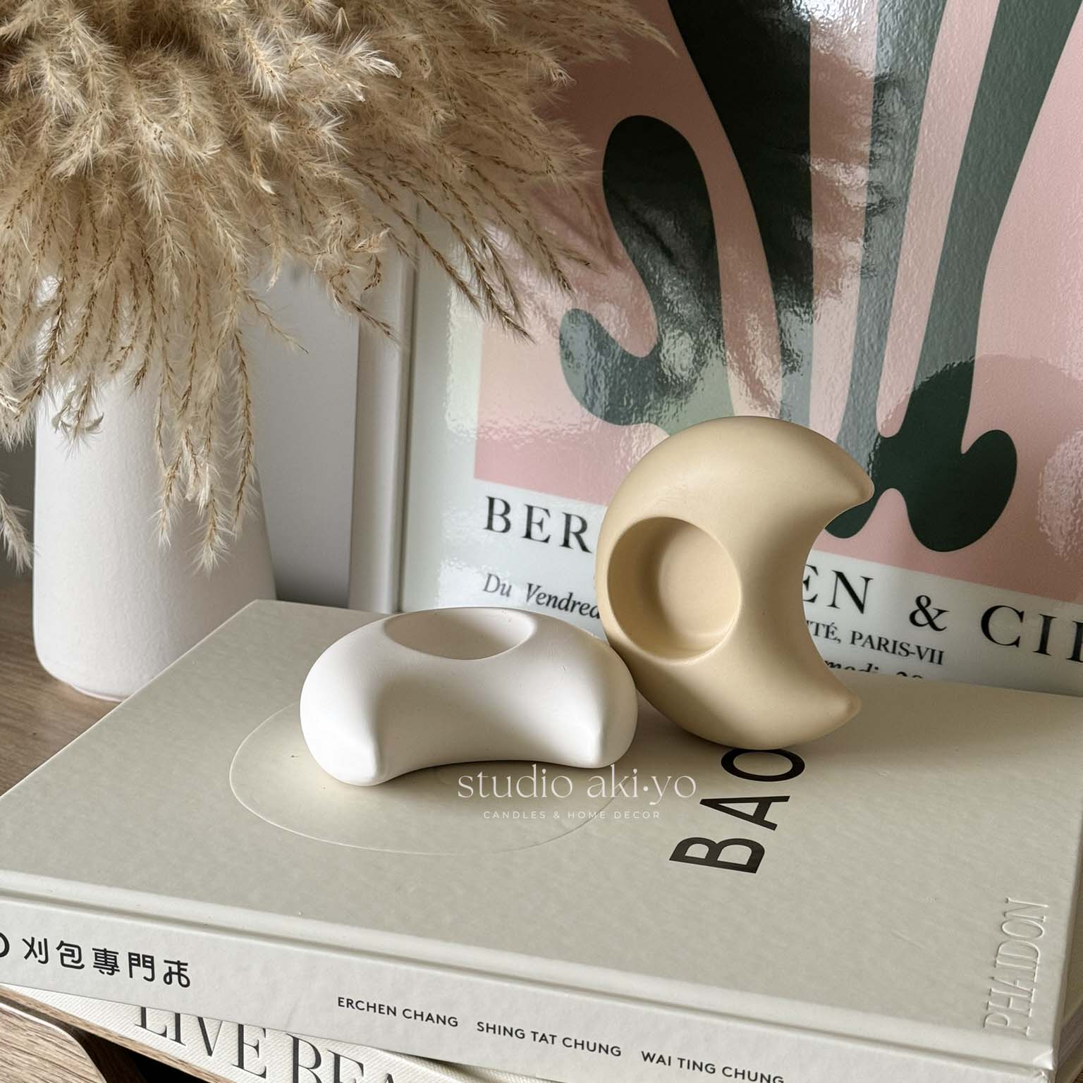 Crescent moon candle holder styled on bedside table with crystals and books