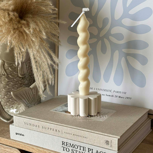 Neutral jesmonite candle holder with floral design and taper candle