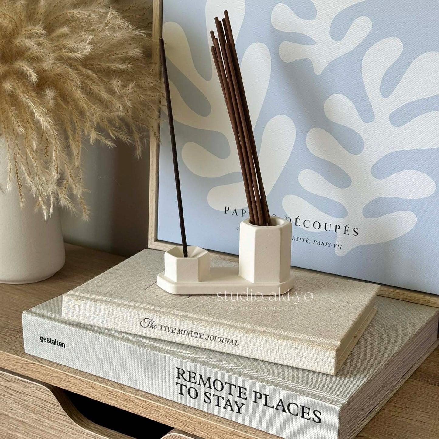 Handcrafted incense hexagon holder with lit stick in modern setting