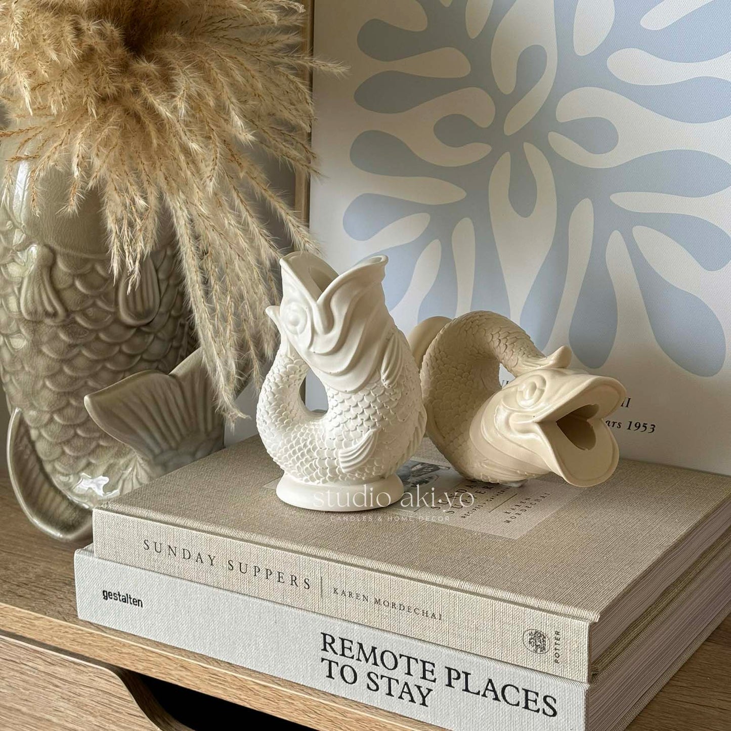 Koi-inspired taper candle holder with fluid sculptural shape