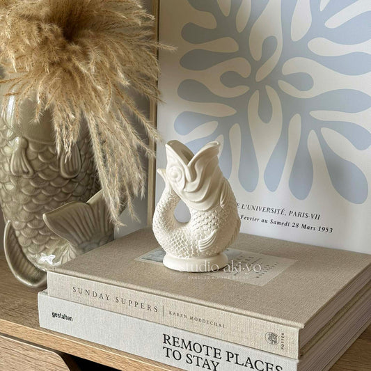 Neutral jesmonite candle holder reflecting natural movement