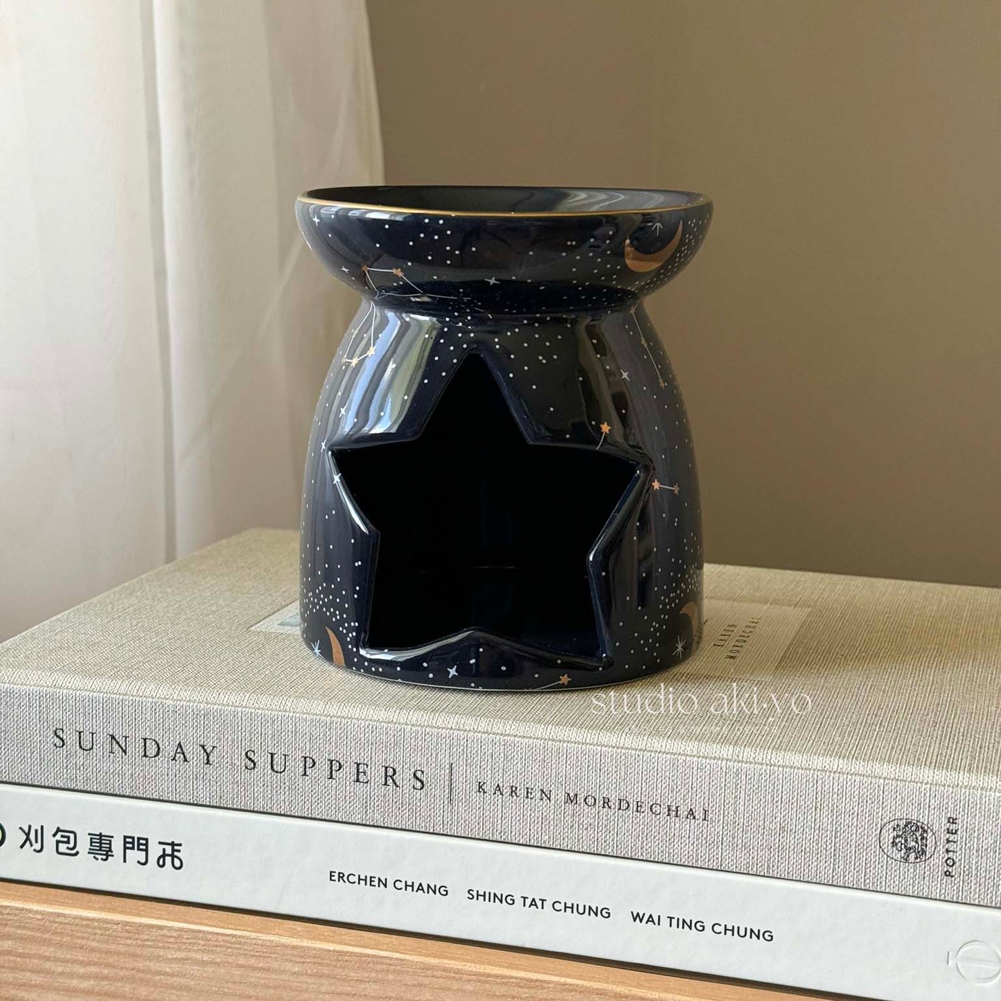 Navy ceramic constellation wax melt burner with gold star cutouts and tealight opening