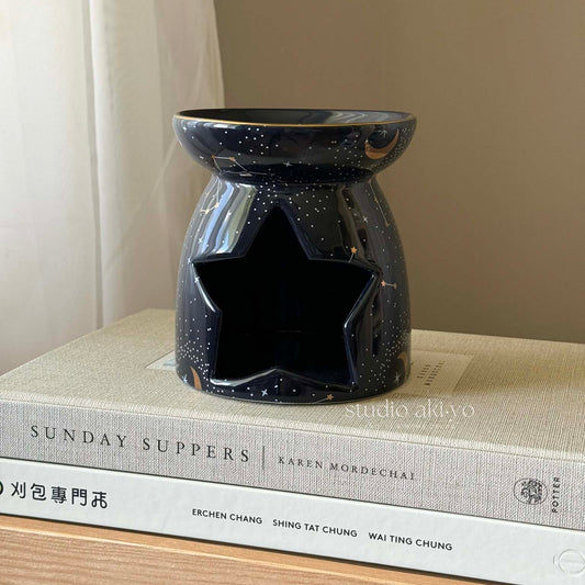 Navy ceramic constellation wax melt burner with gold star cutouts and tealight opening