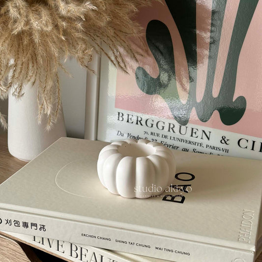 Pumpkin-shaped tealight candle holder made from neutral-toned jesmonite