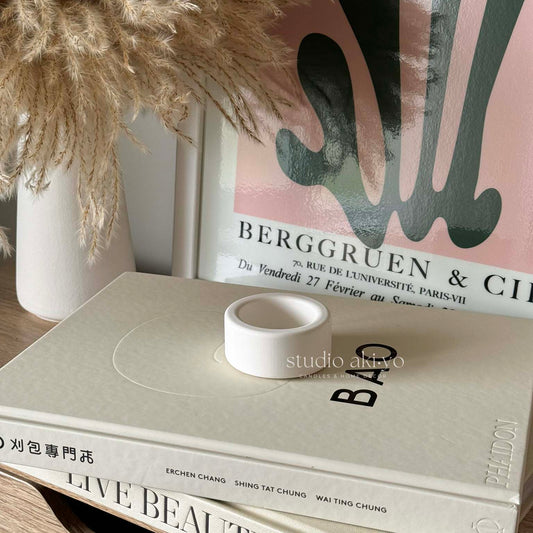 Soft-toned candle holder styled in a modern interior