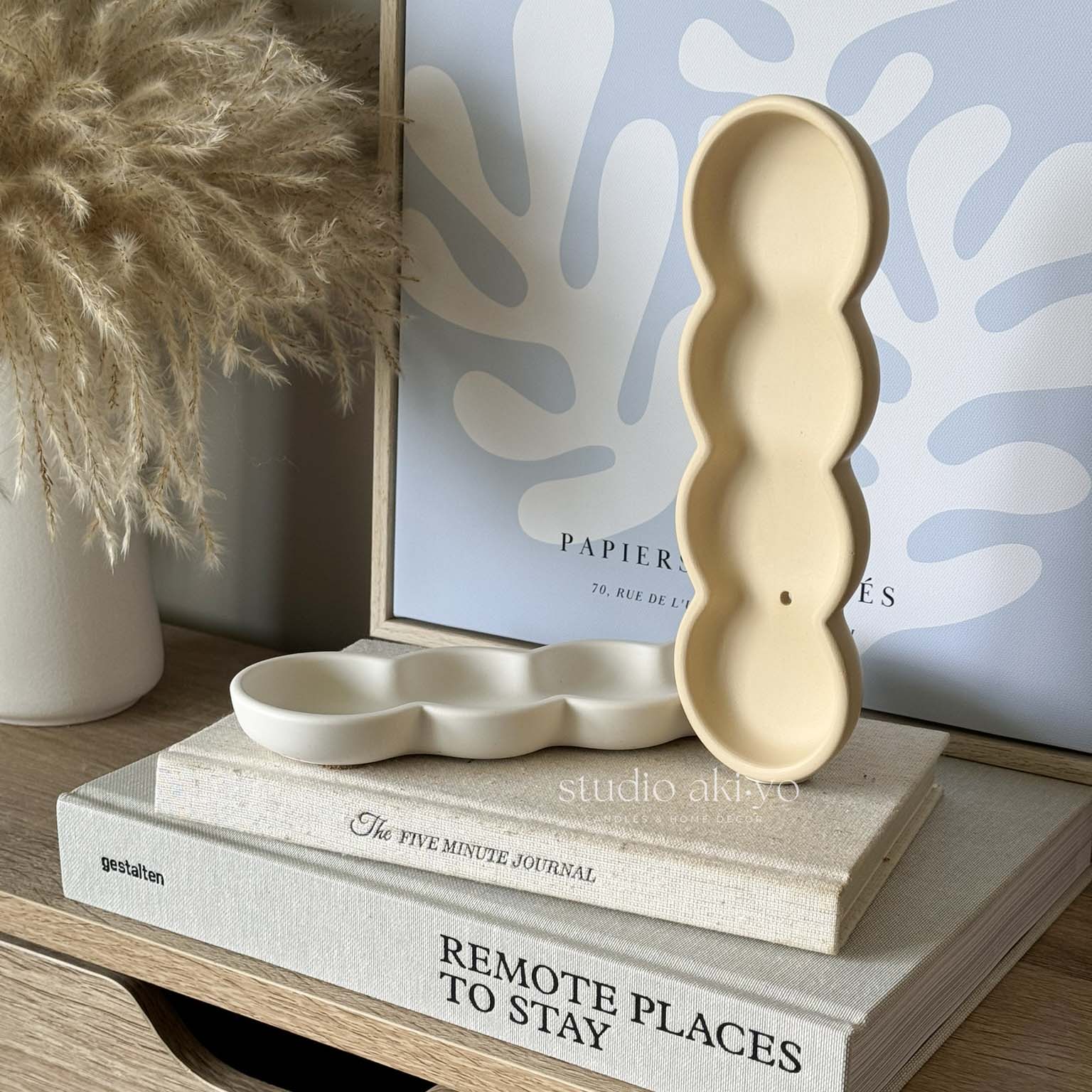Wavy jesmonite incense holder with soft neutral finish on white background