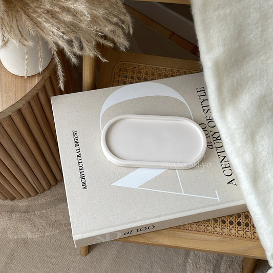 Neutral oval trinket tray made of smooth jesmonite