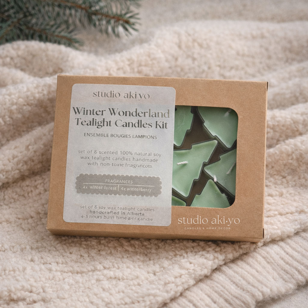 Winter Wonderland Tealight Candles Kit packaging on a textured surface with a branch in the background