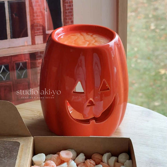 Long ceramic Jack‑O‑Lantern wax melt burner with smiling pumpkin face for tealights