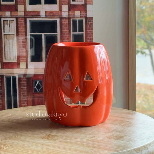 Long ceramic Jack‑O‑Lantern wax melt burner with smiling pumpkin face for tealights