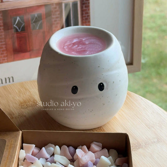 Ceramic mummy-shaped wax melt burner with white bandage detail perfect for fragrance oils and wax melts