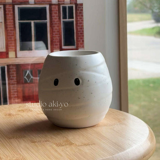 Ceramic mummy-shaped wax melt burner with white bandage detail perfect for fragrance oils and wax melts