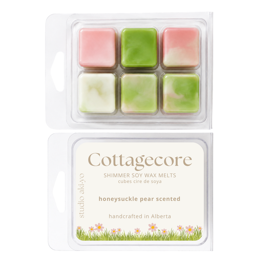 Studio Aldyo Cottagecore shimmer soy wax melts in a clear clamshell package, showing six marbled wax cubes in pink, green, and creamy white, with the front label visible below.