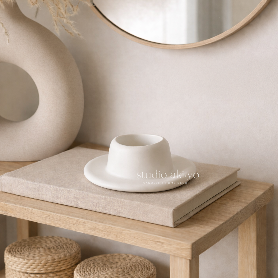 White ceramic cup and saucer on a wooden table with a neutral background