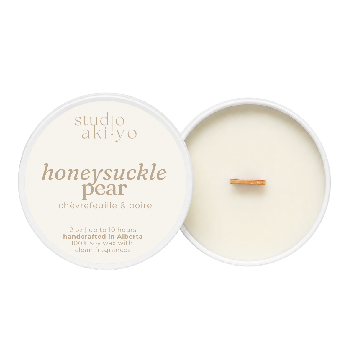 A round soy wax candle shown open with the cream-colored lid beside it on a white background. The lid reads 'studio aki yo' and 'honeysuckle pear' with smaller text 'châfrefeuille & poire.