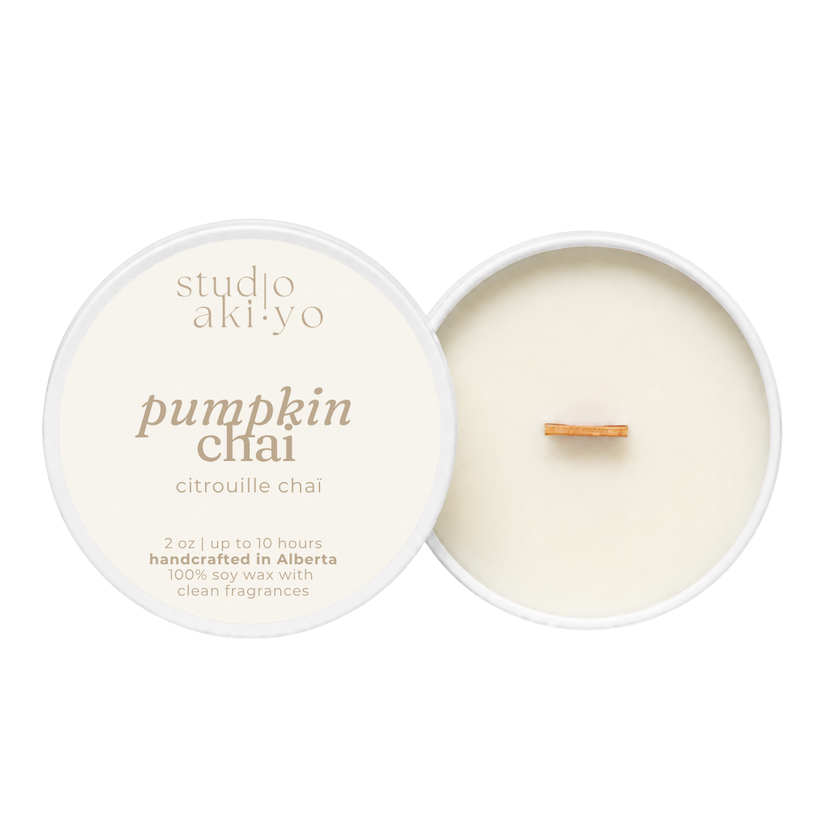 A round soy wax candle shown open with the cream-colored lid beside it on a white background. The lid reads 'studio aki yo' and 'pumpkin chai' with smaller text 'citrouille chai.
