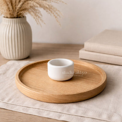 Wooden tray with a white ceramic cup on a neutral background, featuring the brand 'studio akiyo'.