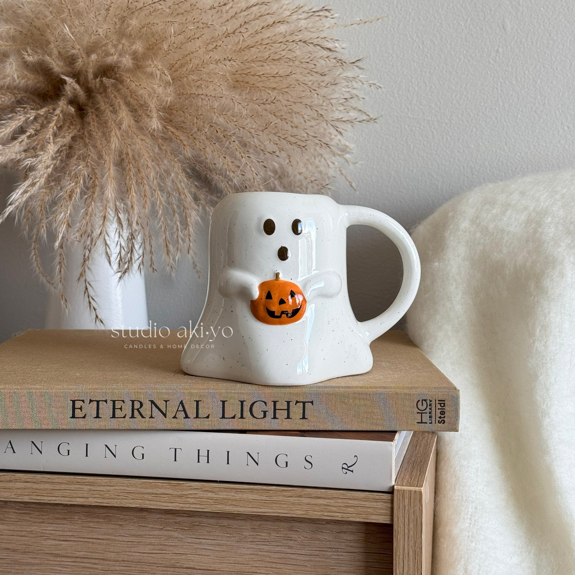 Speckled ceramic mug with ghost and pumpkin design